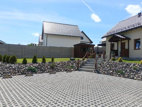 a house with a brick driveway in front of a house at Letnisko domek z Sauną i Balią in Lubawka