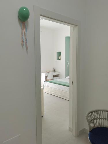 a bedroom with a door leading to a bed at Le Cromie di Amelie in Ceglie Messapica