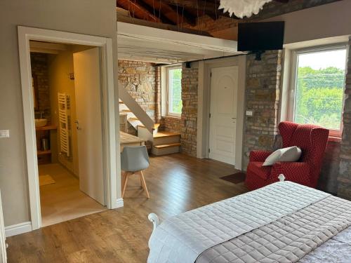 a bedroom with a bed and a staircase in a room at A un passo dal Collio in Mossa