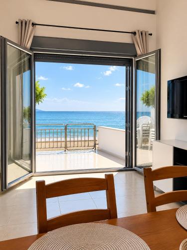 a living room with a view of the ocean at Beachfront Paradise in Leptokarya
