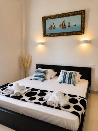 a bedroom with two beds with towels on them at Beachfront Paradise in Leptokarya
