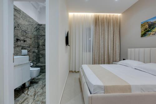 a hotel room with a bed and a bathroom at Swimming Pool - Marko Studios Berat in Berat
