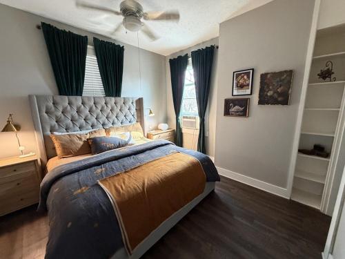 a bedroom with a bed and a ceiling fan at Barrel House on Derby Row in Louisville