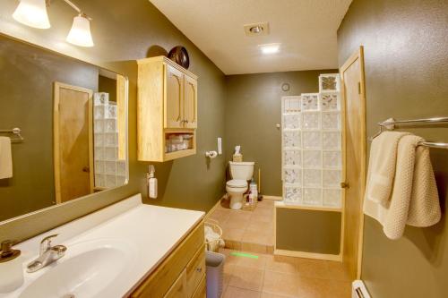 a bathroom with a sink and a toilet at Mountain Views + BBQs: Updated Cody Cabin in Cody
