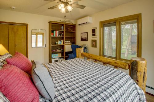 a bedroom with a bed and a book shelf at Mountain Views + BBQs: Updated Cody Cabin in Cody