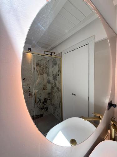 a bathroom with a mirror on the wall at Casa Amor Iseo Lake in Riva di Solto