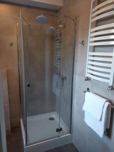 a shower with a glass door in a bathroom at Apartamenty Słoneczna 42 in Gdynia