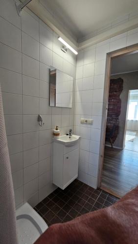 a bathroom with a sink and a toilet at Ülejõe Apartment with Free Parking in Pärnu