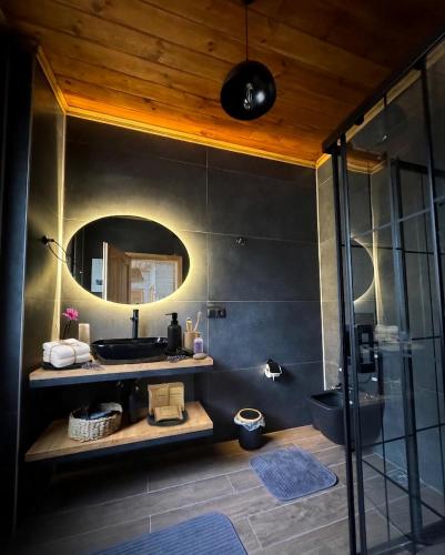 a bathroom with a sink and a mirror at Villa Del Rio Karadeniz River Palace Ayder in Çamlıhemşin