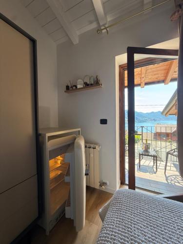 a bedroom with a bed and a view of a balcony at Casa Amor Iseo Lake in Riva di Solto