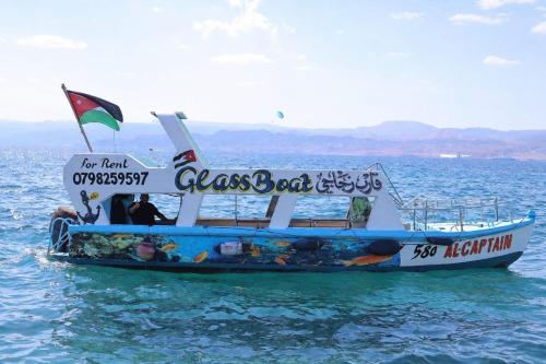 a boat in the water with people sitting on it at AlCaptian Glassboat in Aqaba
