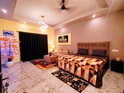 a bedroom with a bed and a living room at MosesVilla in Jabalpur