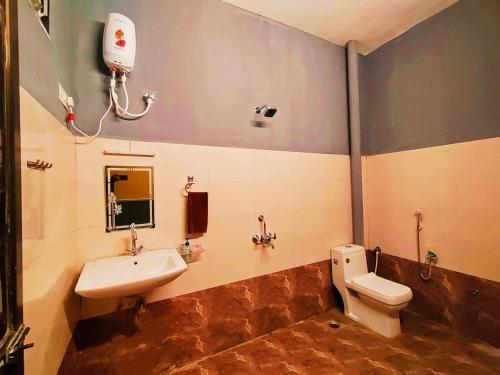a bathroom with a sink and a toilet at MosesVilla in Jabalpur