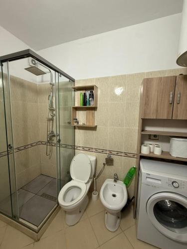 a bathroom with a shower and a toilet and a sink at HRS Luxury Apartments in Durrës