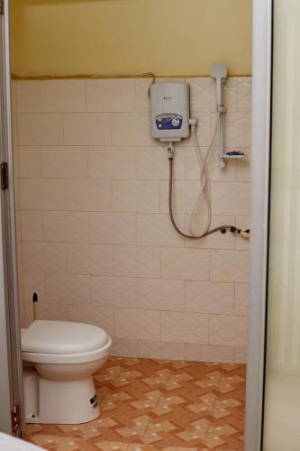 a bathroom with a toilet and a shower at Morika Hotel in Mbarara