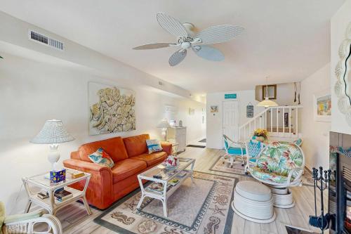 a living room with an orange couch and chairs at Mallard Lakes - 38082 Mockingbird Ln in Selbyville