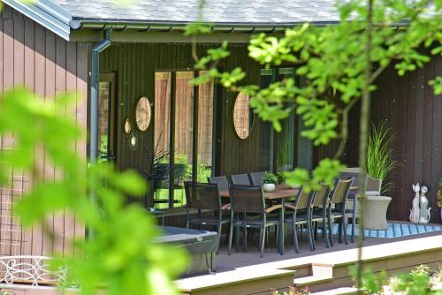 a patio with a table and chairs on it at Pramogų namelis in Naručionys