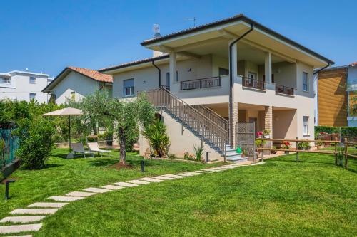a large house with a lawn in front of it at Arlu lake house Lazise in Lazise