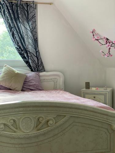 a bedroom with a large bed with a window at Zserbó lak in Kisapostag