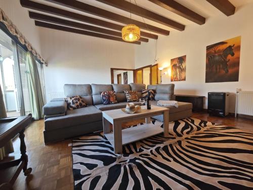 a living room with a couch and a table at Villa Serra Brava mt Gemeinschatspool, 3 Apartments in Lloret de Mar