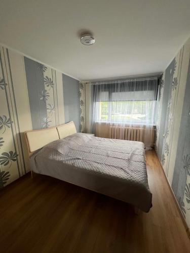 a bedroom with a bed in a room with a window at Tähe majutus in Mustvee