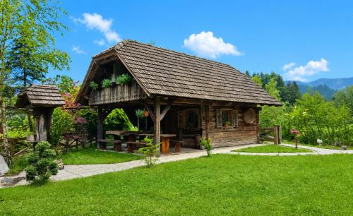 a pavilion in a park with a green lawn at Hiša Vasenka in Laze v Tuhinju