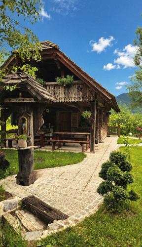 a wooden building with a bench in front of it at Hiša Vasenka in Laze v Tuhinju