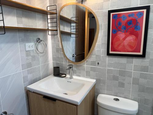 a bathroom with a sink and a mirror at la maguana - cozy and beautiful 3BR home with pool in Santiago de los Caballeros