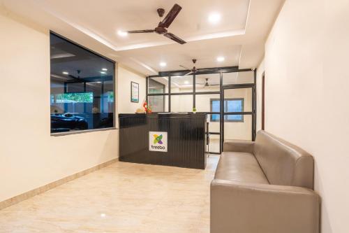 a living room with a couch and a bar at Treebo The Trio, Karmanghat in Hyderabad