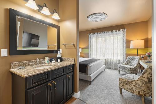 a bathroom with a sink and a bedroom with a bed at Summer Creek Inn in Johnson Siding