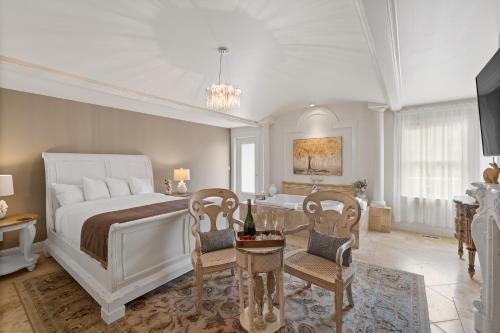 a bedroom with a bed and a table and chairs at Summer Creek Inn in Johnson Siding