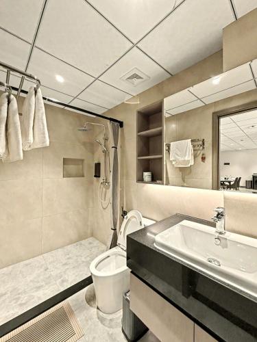 a bathroom with a toilet and a sink at Modera Residence Grand Phnom Penh, Serviced Apartments in Phnom Penh