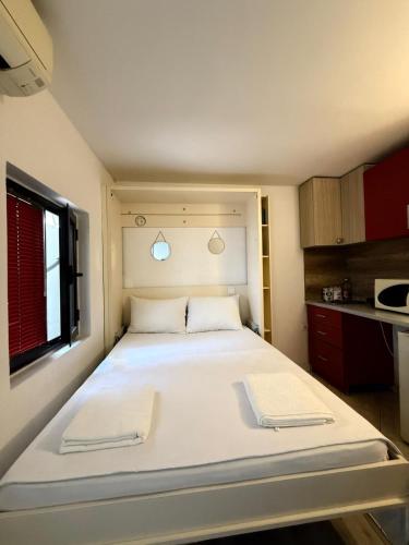 a large white bed in a small room at Majka 2 Apartments in Kotor
