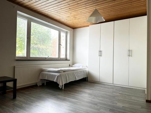 a bedroom with a bed and a window at Lägenhet Svängsta in Svängsta