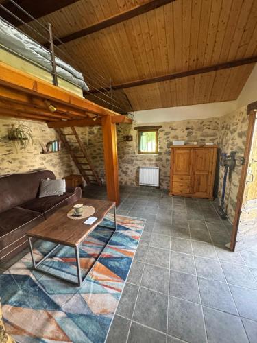 a living room with a couch and a table at Gîte de Rille in Castelnau-Durban