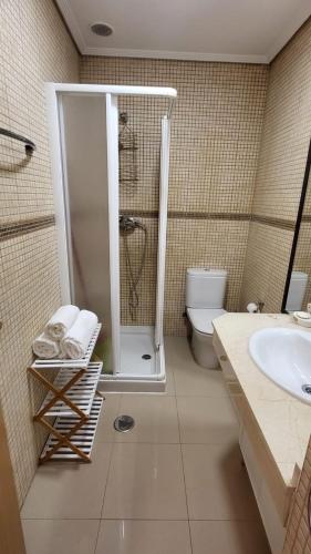 a bathroom with a shower and a toilet and a sink at Vigo a un paso in Vigo