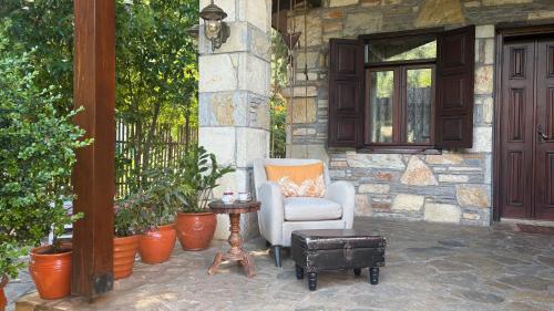 a patio with a chair and a table and a building at Kamarca House Hotel in Ortaca