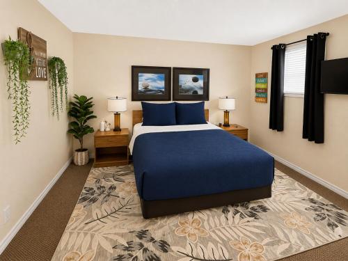 a bedroom with a blue bed and two lamps at Poolside Retreat at Kimberling Crossing in Kimberling City