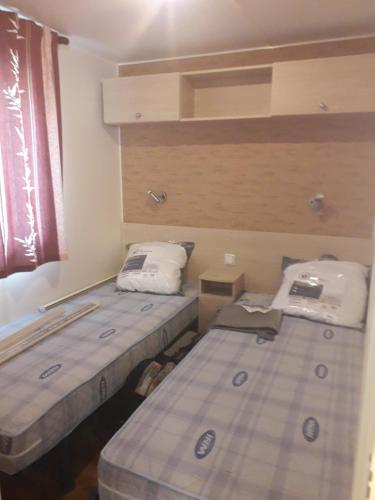 a room with two beds in a room with a window at danseuse 33 in Parentis-en-Born