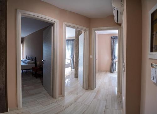 a hallway with two doors leading to a bedroom at La Sirenetta Residence in Syvota