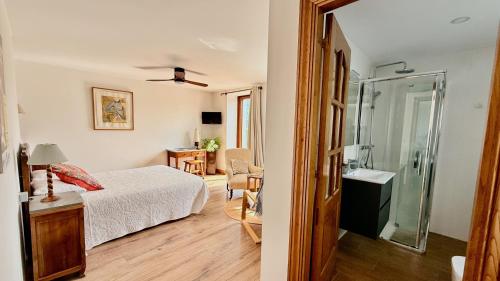 a bedroom with a bed and a bathroom with a shower at Matxiku Aurre in Berástegui