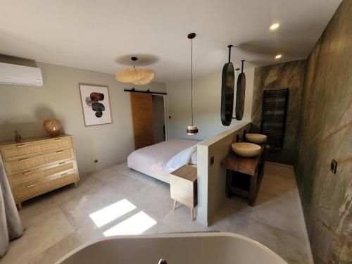 a bedroom with a bed and a bath tub at L'Écrin de Nature Panoramic View & Prestige in Saint-Marcel-lès-Annonay