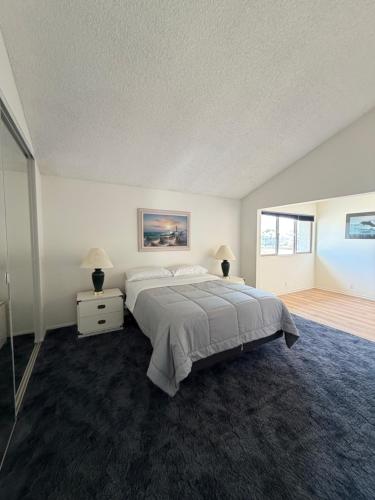 a large bedroom with a large bed and a window at Coastal Comfort in Oxnard