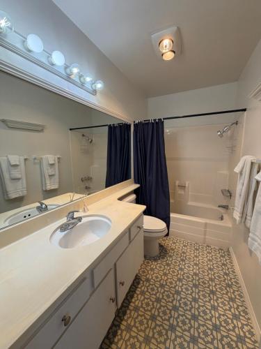 a bathroom with a sink and a tub and a toilet at Coastal Comfort in Oxnard