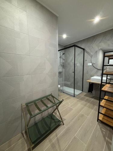 a bathroom with a glass shelf and a shower at Al Mar pensión in Alicante