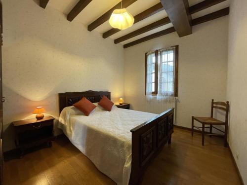 a bedroom with a large bed and a window at Iagonia in Lacarry-Arhan-Charritte-de-Haut