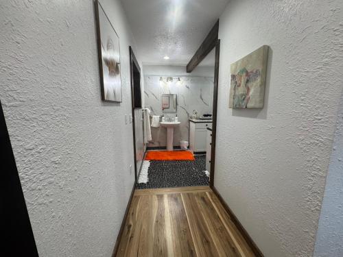 a hallway leading to a bathroom with a sink at Lakeview 4BR Huge Deck Dog Friendly ADA in Lakeside