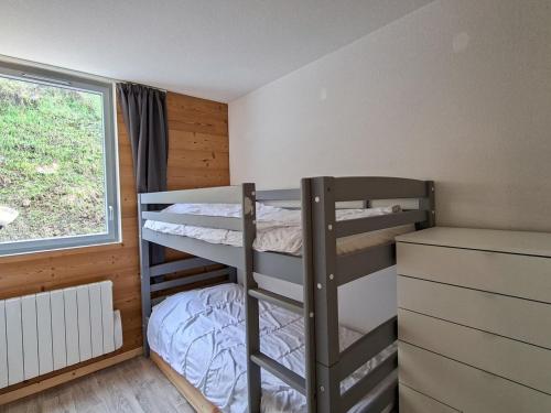 a bedroom with two bunk beds and a window at Spacieux appartement 3 pièces au centre de Flaine - FR-1-425-28 in Flaine