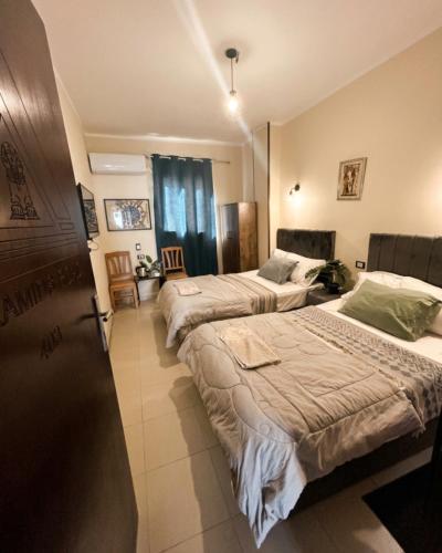 a hotel room with two beds in a room at Pyramids Road Guest House in Cairo
