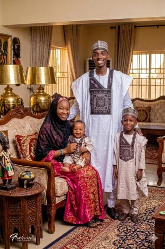 a man and a woman and two children in a living room at Aromat villa in Kano